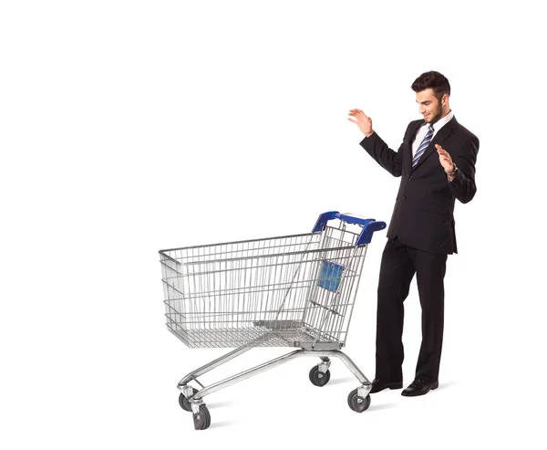 Businessman with shopping cart — Stock Photo, Image