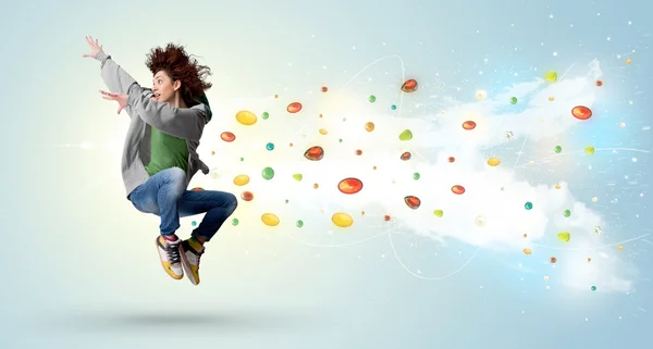 Beautiful woman jumping with colorful gems and crystals on the b — Stock Photo, Image