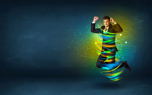 Excited business man jumping with energy colourful lines — Stock Photo, Image