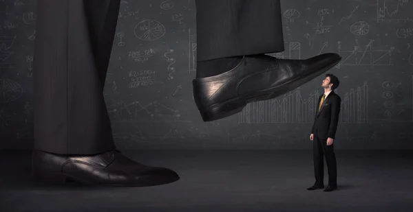 Huge leg stepping on a tiny businnessman concept — Stock Photo, Image