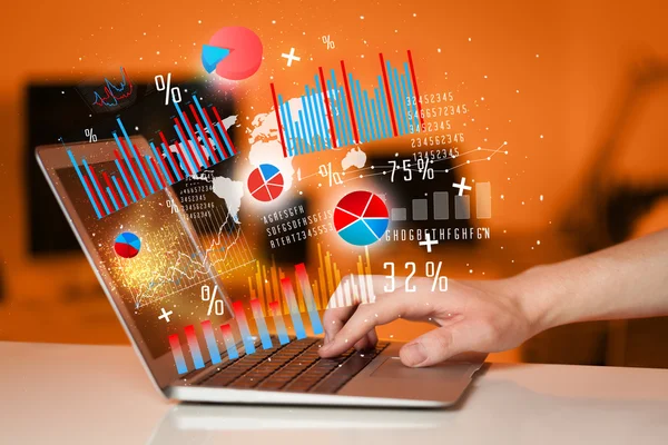 Hand typing on modern laptop notebook computer with graph icons — Stock Photo, Image