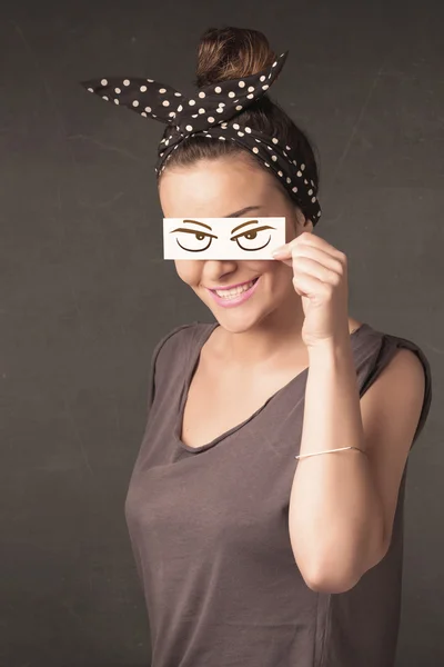 Young person holding paper with angry eye drawing — Stock Photo, Image