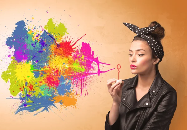 Cute girl blowing colorful splash graffiti — Stock Photo, Image