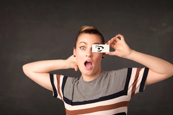 Silly youngster looking with hand drawn eye paper — Stock Photo, Image