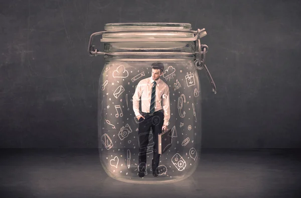 Business man captured in glass jar with hand drawn media icons c — Stock Photo, Image
