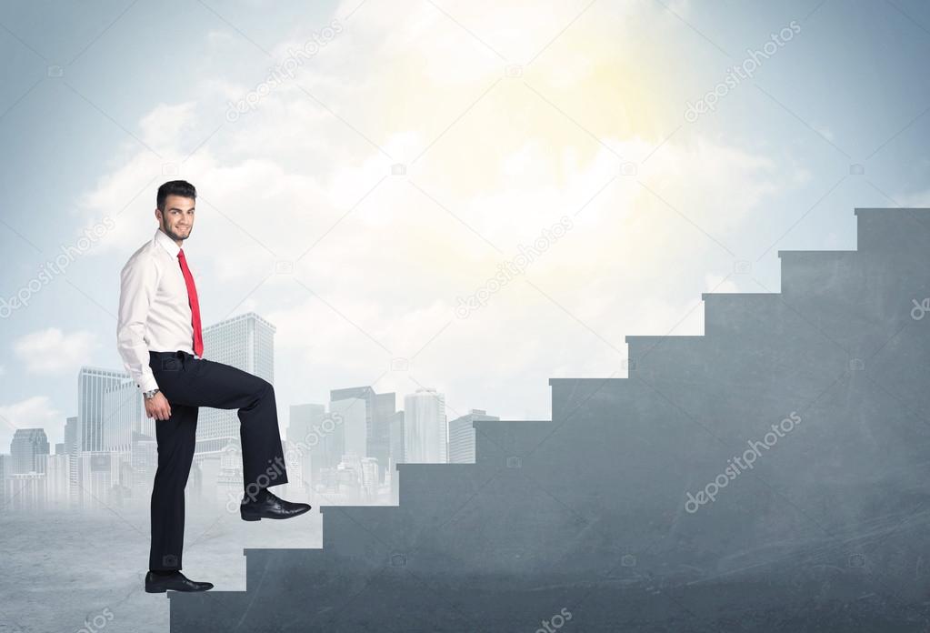 Businessman climbing up a concrete staircase concept