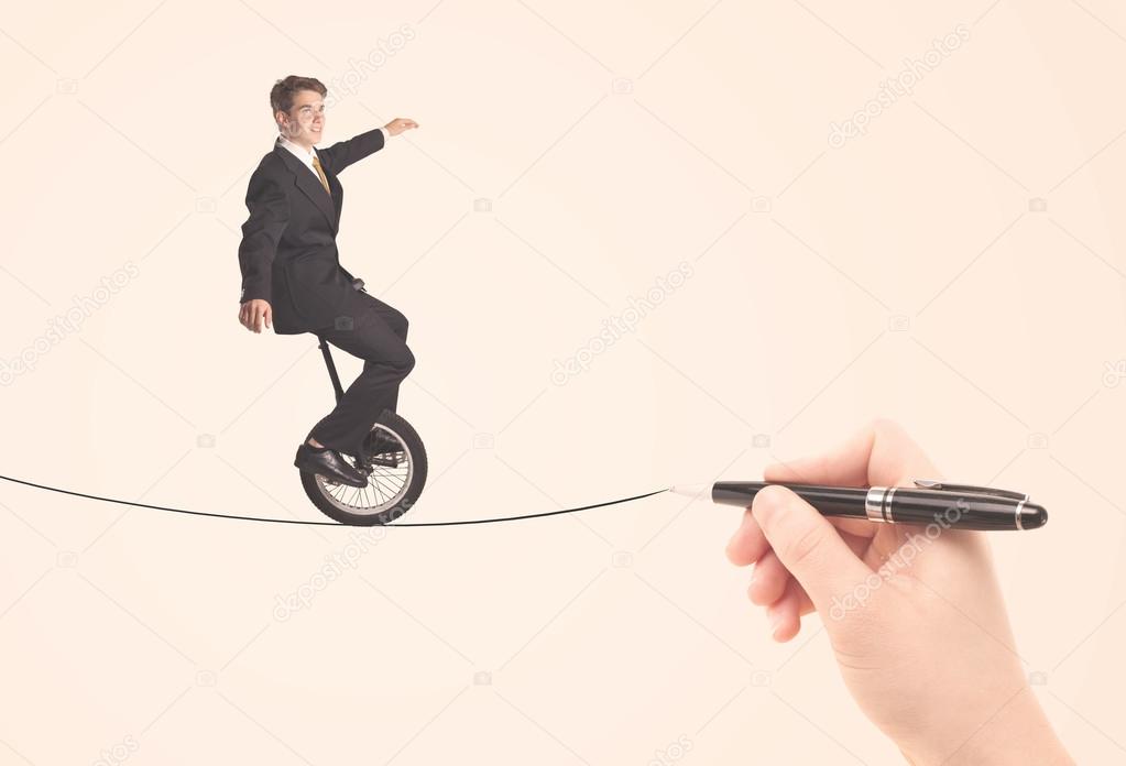 Businessman riding monocycle on a rope drawn by hand