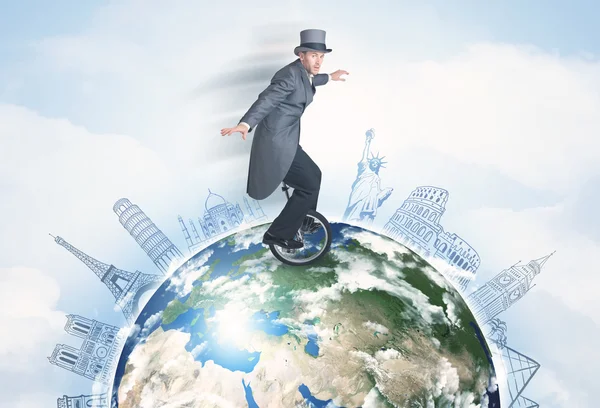 Man riding unicycle around the globe with major cities — Stock Photo, Image