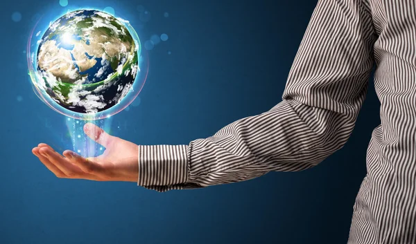 Businessman holding a glowing earth globe — Stock Photo, Image