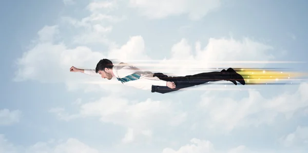 Happy business man flying fast on the sky between clouds — Stock Photo, Image
