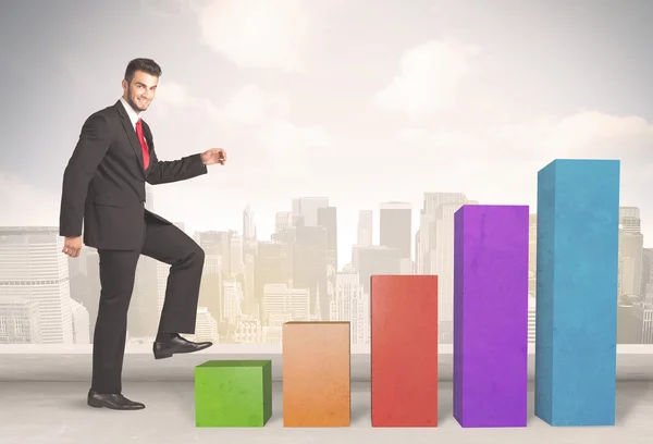 Business person climbing up on colourful chart pillars concept — Stock Photo, Image