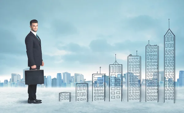 Business man climbing up on hand drawn buildings in city — Stock Photo, Image