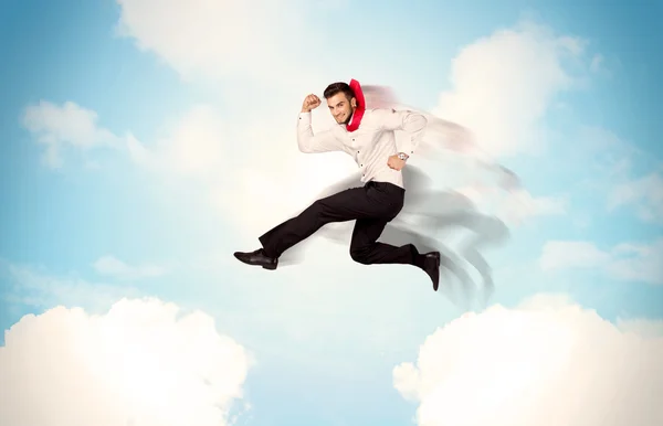 Business person jumping over clouds in the sky — Stock Photo, Image