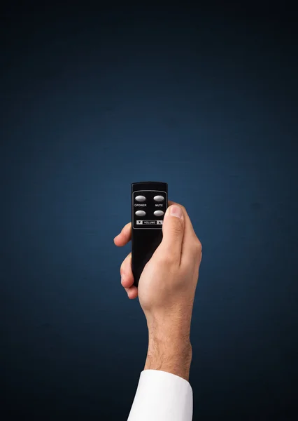 Hand with remote control — Stock Photo, Image