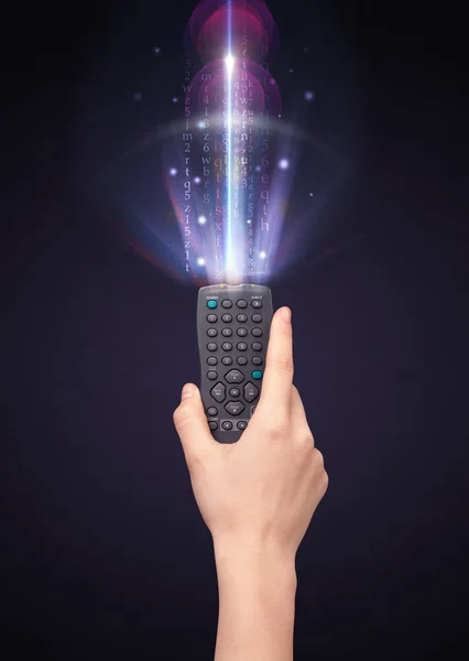 Hand with remote control and shining numbers