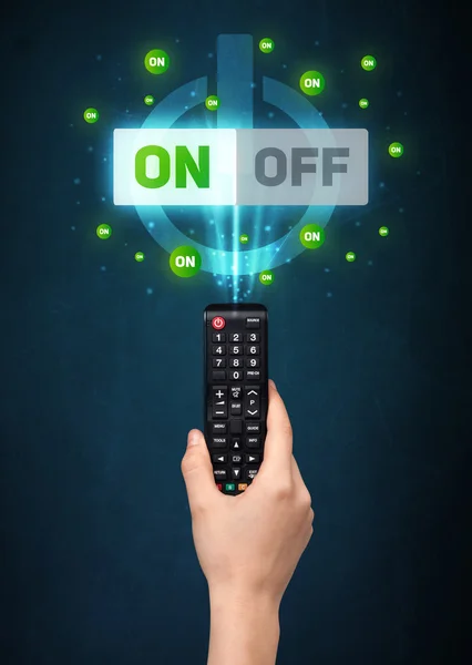 Hand with remote control and on-off signals