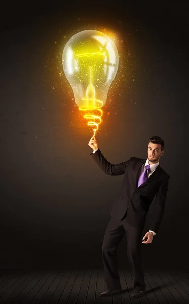 Businessman with an idea bulb — Stock Photo, Image