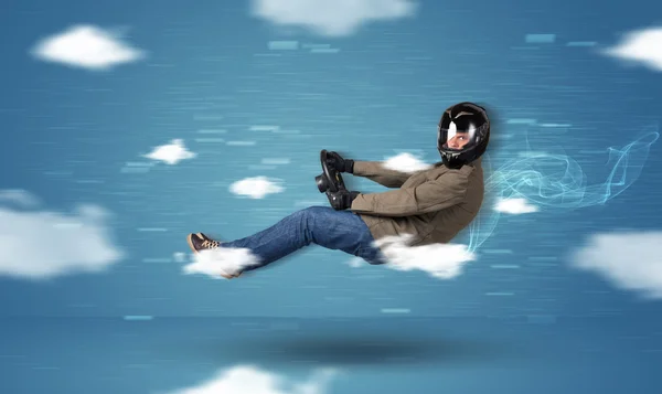 Funny racedriver young man driving between clouds concept — Stock Photo, Image