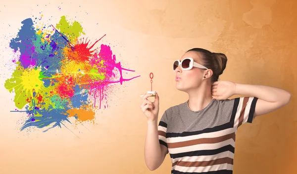 Cute girl blowing colorful splash graffiti — Stock Photo, Image