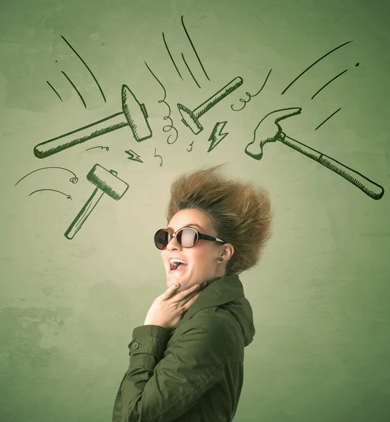 Tired woman with hair style and headache hammer symbols — Stock Photo, Image