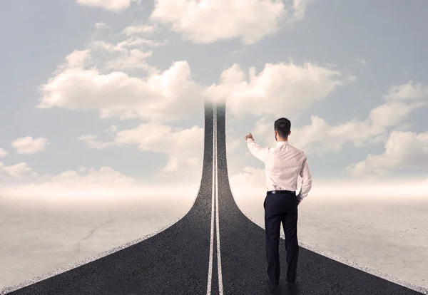 Businessman looking at 3d road that goes up in the sky — Stock Photo, Image