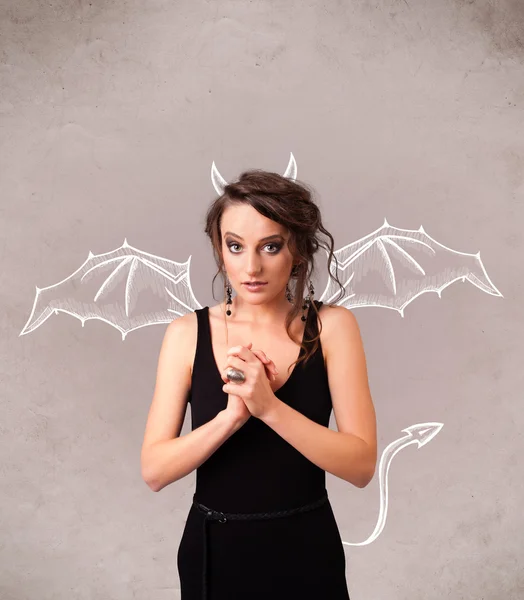 Young girl with devil horns and wings drawing — Stock Photo, Image