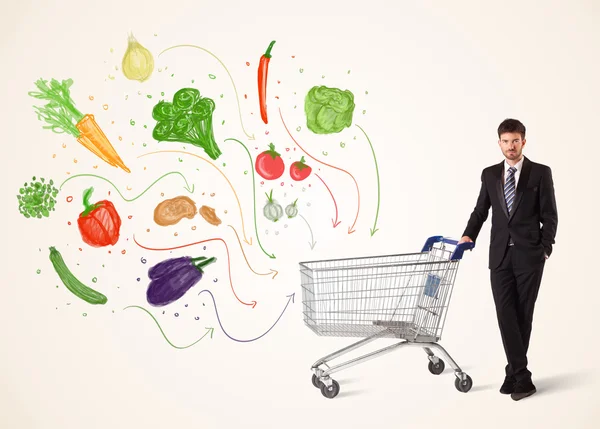 Podnikatel s nákupním vozíkem se zeleninou — Stock fotografie