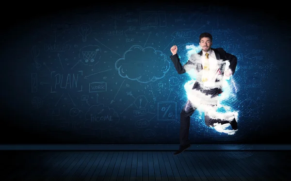 Happy business man jumping with storm cloud around him — Stock Photo, Image