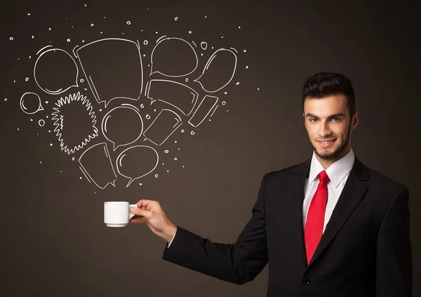 Businessman holding a white cup with speech bubbles — Stock Photo, Image