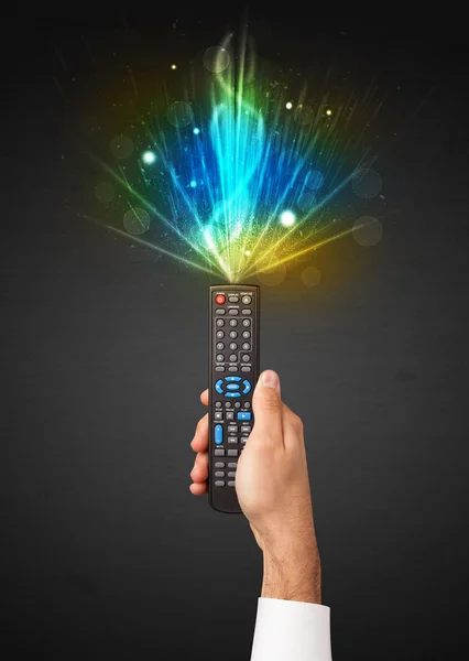 Hand with remote control and explosive signal — Stock Photo, Image