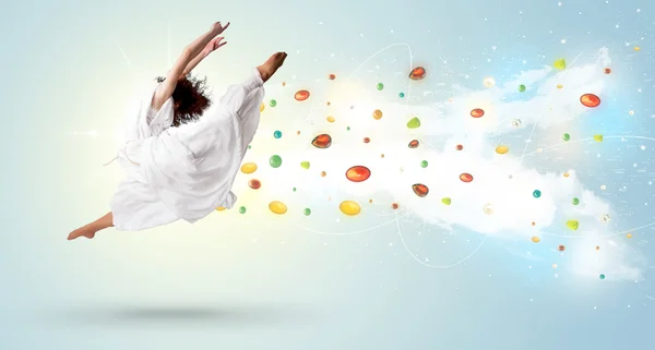 Beautiful woman jumping with colorful gems and crystals on the b — Stock Photo, Image