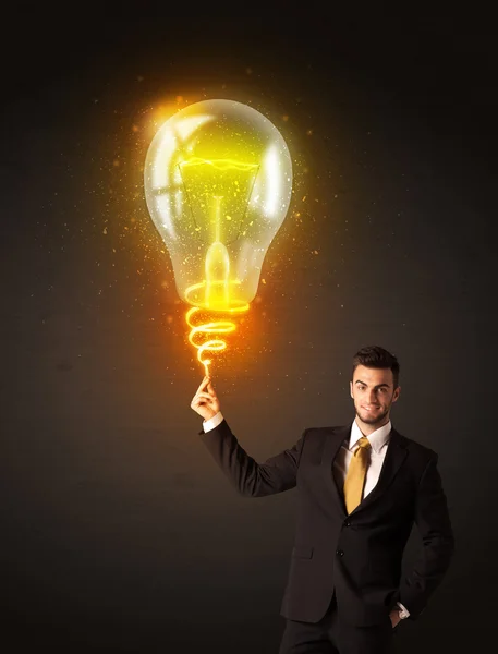 Businessman with an idea bulb — Stock Photo, Image