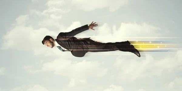 Happy business man flying fast on the sky between clouds — Stock Photo, Image