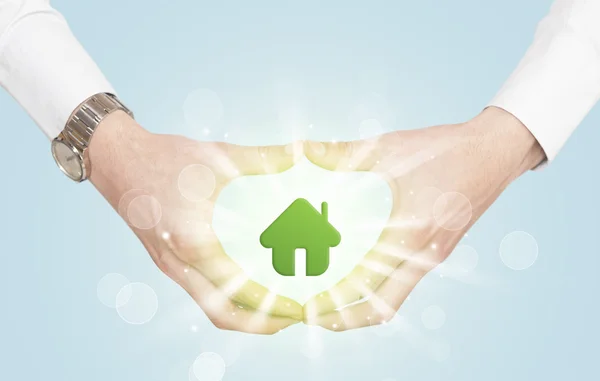 Hands creating a form with green house — Stock Photo, Image