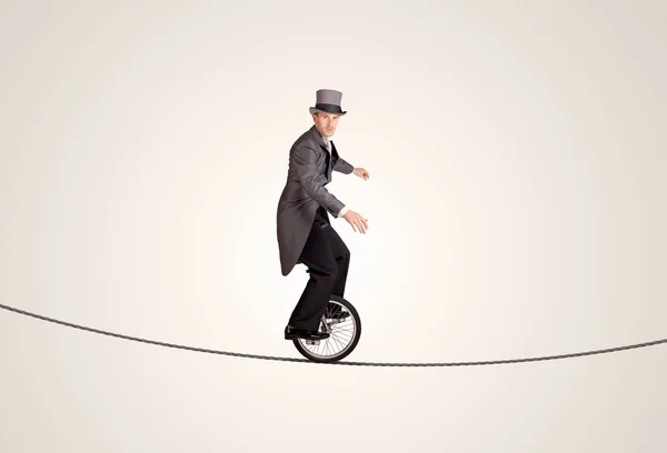 Extreme business man riding unicycle on a rope — Stock Photo, Image