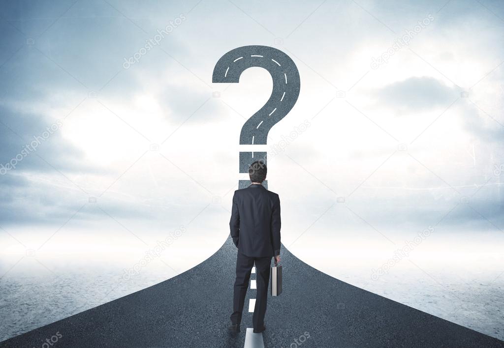 Business person lokking at road with question mark sign