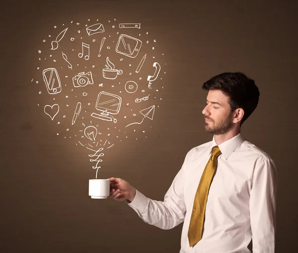 Businessman holding a white cup with social media icons — Stock Photo, Image