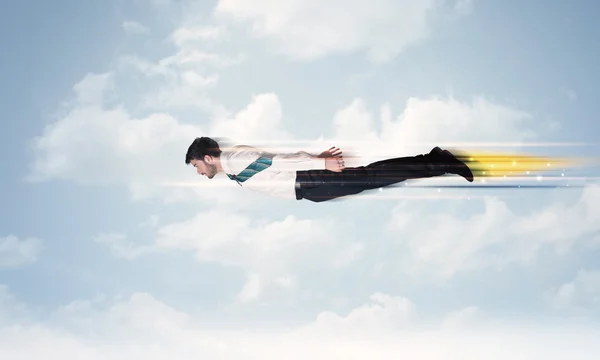 Happy business man flying fast on the sky between clouds — Stock Photo, Image