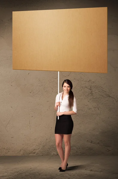 Businesswoman with blank cardboard — Stock Photo, Image