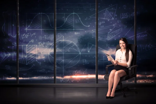 Businesswoman holding tablet in office room with graph charts on — Stock Photo, Image