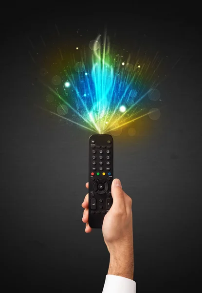 Hand with remote control and explosive signal — Stock Photo, Image