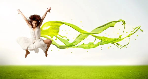 Pretty girl jumping with green abstract liquid dress — Stock Photo, Image