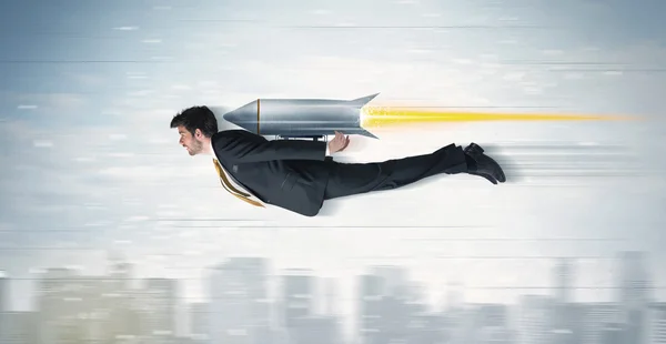 Superhero business man flying with jet pack rocket above the cit — Stock Photo, Image