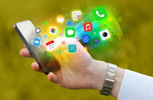 Hand holding smartphone with colorful app icons — Stock Photo, Image