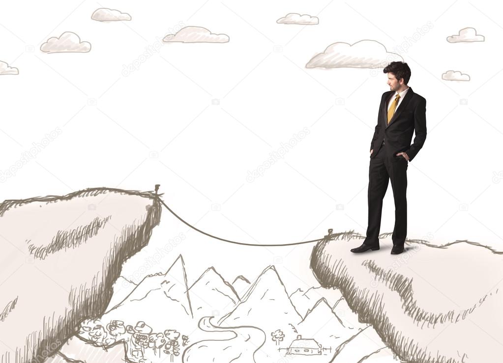 Businessman with drawn edge of mountain