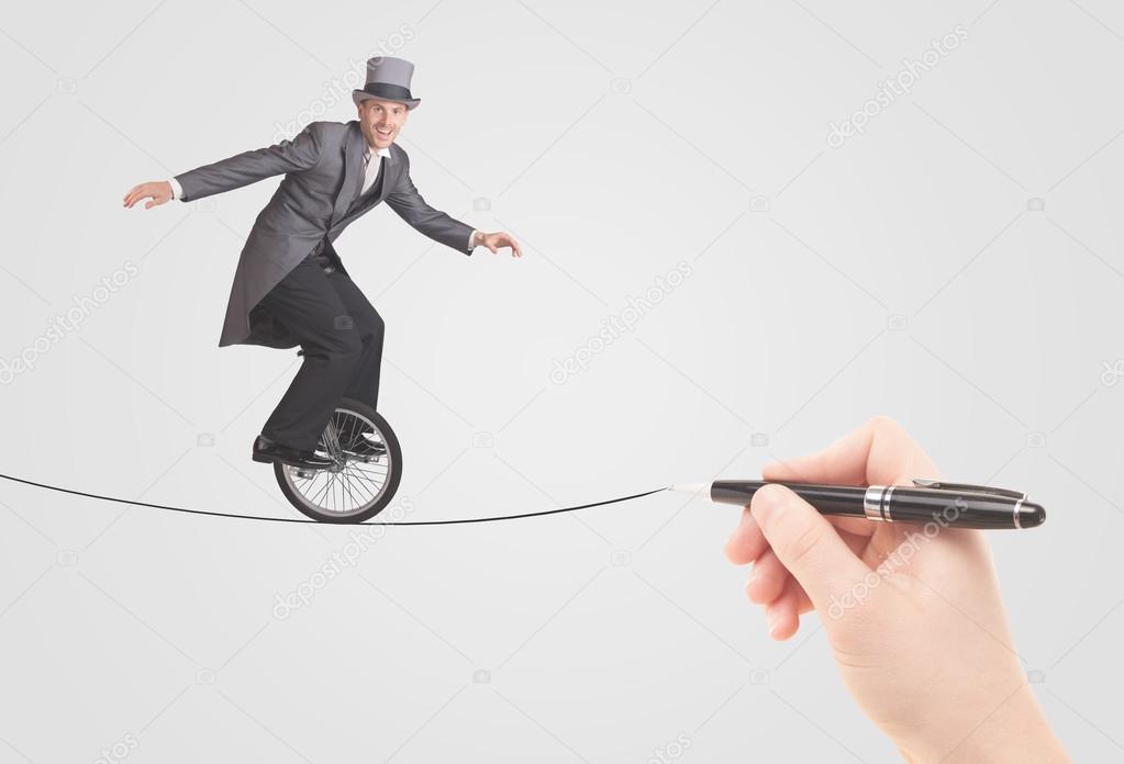 Businessman riding monocycle on a rope drawn by hand