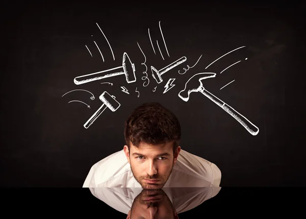 Depressiver Geschäftsmann sitzt unter Hammer — Stockfoto