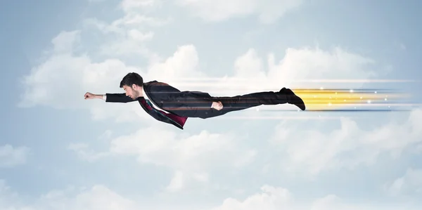 Happy business man flying fast on the sky between clouds — Stock Photo, Image