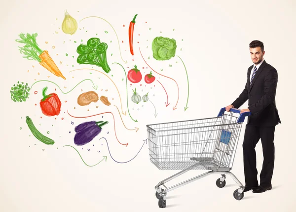 Empresário com carrinho de compras com legumes — Fotografia de Stock