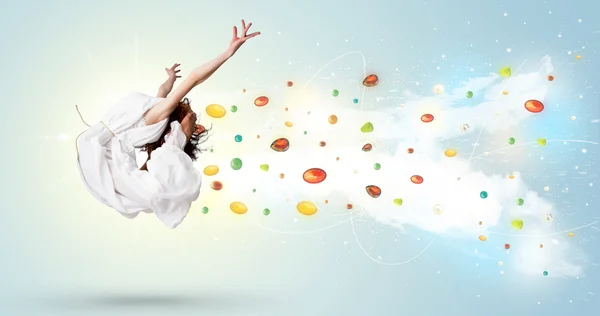 Schöne Frau springt mit bunten Edelsteinen und Kristallen auf der B — Stockfoto
